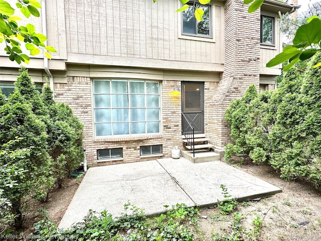 31404 Hunters Circle Dr, Farmington, MI 48334 - doorway to property featuring a patio and brick siding