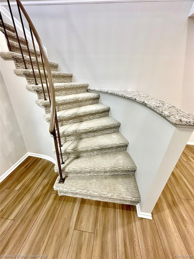 31404 Hunters Circle Dr, Farmington, MI 48334 - stairs featuring wood finished floors and baseboards