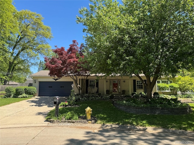 37298 Robindale Ct, Clinton Township, MI 48036 - obstructed view of property with a garage, concrete driveway, and brick siding