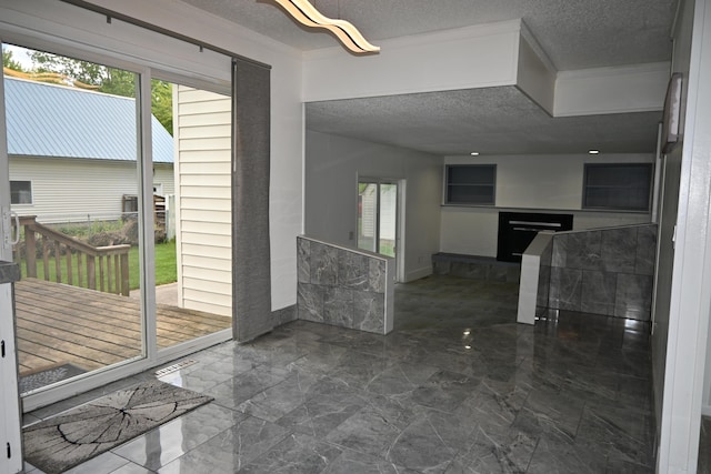 5830 Oneil St, Twin Lake, MI 49457 - interior space with a textured ceiling, plenty of natural light, dark marble finish flooring, and a fireplace with raised hearth