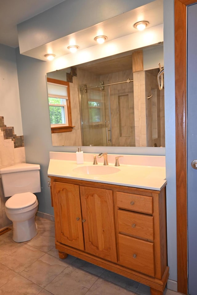 5830 Oneil St, Twin Lake, MI 49457 - bathroom featuring toilet, vanity, a shower with shower door, and tile patterned floors