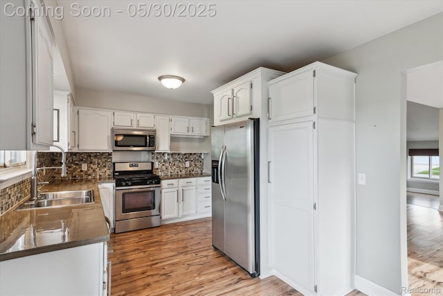 45127 Fair Oaks Dr, Canton, MI 48187 - kitchen featuring stainless steel appliances, a sink, tasteful backsplash, and light wood-style flooring