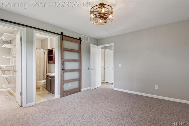 45127 Fair Oaks Dr, Canton, MI 48187 - unfurnished bedroom with light colored carpet, ensuite bath, a barn door, baseboards, and a chandelier