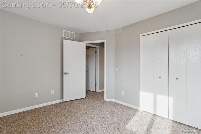45127 Fair Oaks Dr, Canton, MI 48187 - unfurnished bedroom with a closet, baseboards, carpet flooring, and a chandelier