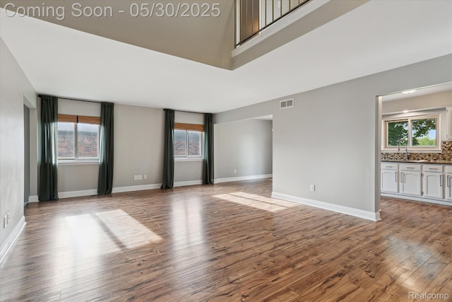 45127 Fair Oaks Dr, Canton, MI 48187 - empty room featuring wood finished floors, plenty of natural light, and baseboards