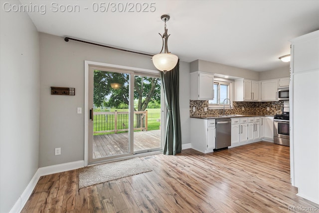 45127 Fair Oaks Dr, Canton, MI 48187 - kitchen with appliances with stainless steel finishes, baseboards, and white cabinetry