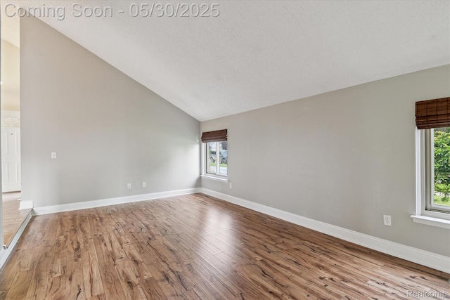 45127 Fair Oaks Dr, Canton, MI 48187 - unfurnished room featuring healthy amount of natural light, wood finished floors, lofted ceiling, and baseboards