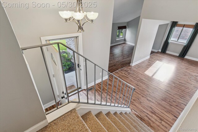45127 Fair Oaks Dr, Canton, MI 48187 - stairs featuring wood finished floors, a chandelier, and baseboards
