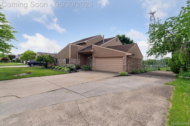 45127 Fair Oaks Dr, Canton, MI 48187 - mid-century home with an attached garage, concrete driveway, brick siding, and a front lawn
