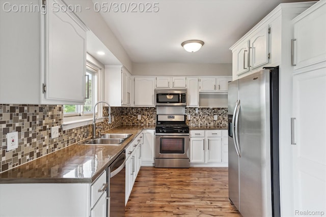 45127 Fair Oaks Dr, Canton, MI 48187 - kitchen featuring stainless steel appliances, a sink, white cabinetry, and backsplash