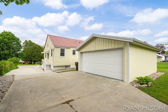 812 Forest St, Ionia, MI 48846 - view of property exterior with a detached garage, metal roof, and an outdoor structure