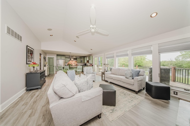 2210 Lindsey Rd, Jackson, MI 49201 - living room featuring healthy amount of natural light, vaulted ceiling, a ceiling fan, light wood-style flooring, and baseboards