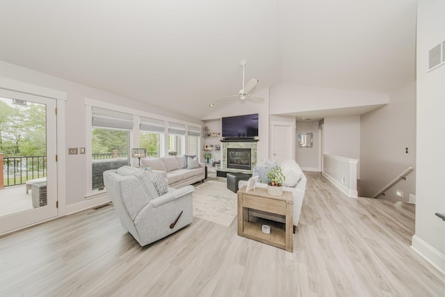 2210 Lindsey Rd, Jackson, MI 49201 - living room featuring ceiling fan, light wood finished floors, baseboards, a fireplace, and high vaulted ceiling