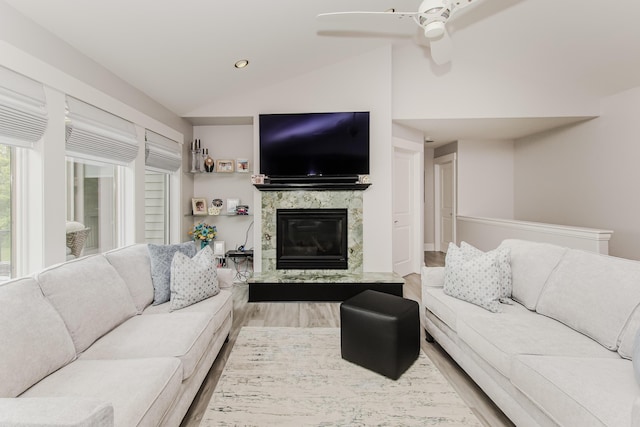 2210 Lindsey Rd, Jackson, MI 49201 - living area with vaulted ceiling, wood finished floors, a premium fireplace, ceiling fan, and recessed lighting