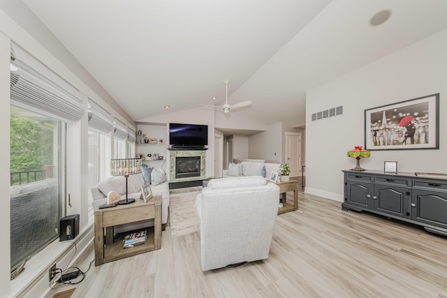 2210 Lindsey Rd, Jackson, MI 49201 - living area with a glass covered fireplace, lofted ceiling, a ceiling fan, light wood-style floors, and baseboards
