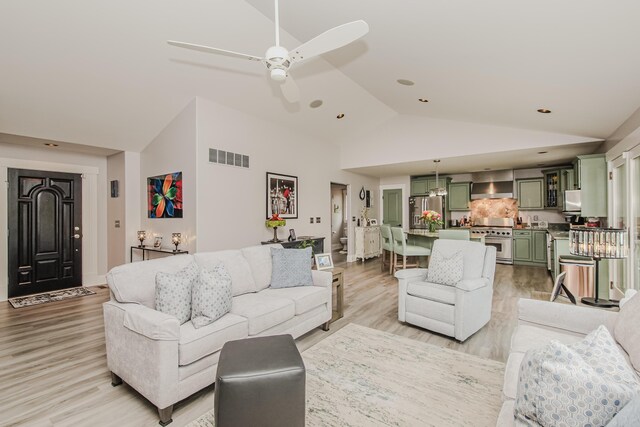 2210 Lindsey Rd, Jackson, MI 49201 - living room featuring light wood-style flooring, a ceiling fan, high vaulted ceiling, and recessed lighting