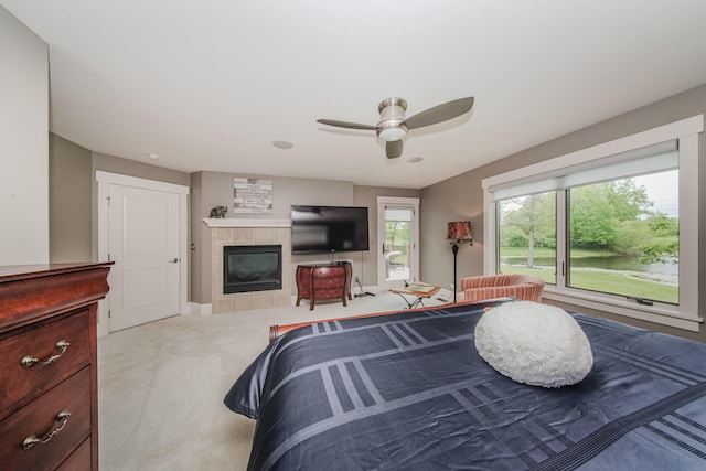 2210 Lindsey Rd, Jackson, MI 49201 - carpeted bedroom featuring a tile fireplace and a ceiling fan