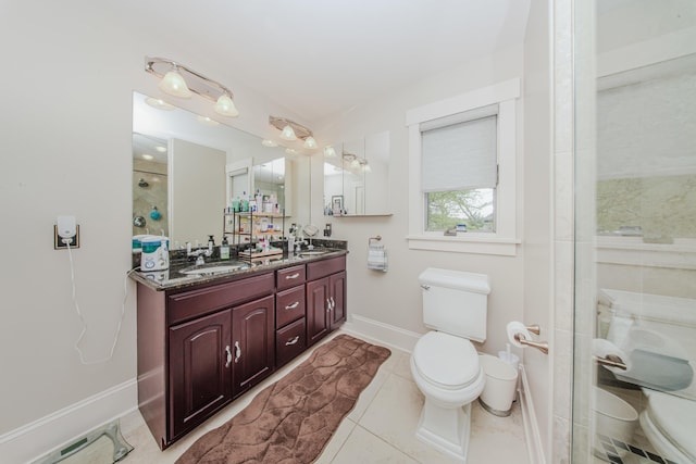 2210 Lindsey Rd, Jackson, MI 49201 - bathroom featuring toilet, double vanity, baseboards, a shower, and tile patterned flooring