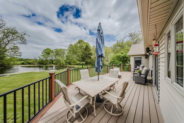 2210 Lindsey Rd, Jackson, MI 49201 - wooden terrace featuring a water view, outdoor dining area, and a lawn