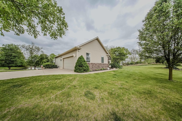 2210 Lindsey Rd, Jackson, MI 49201 - view of property exterior with driveway, stone siding, a yard, and a garage