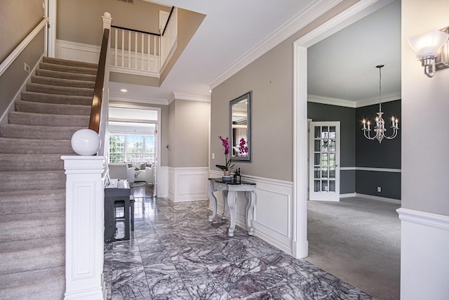 7340 Royal Ridge Dr SE, Caledonia, MI 49316 - foyer featuring a chandelier, crown molding, marble finish floors, stairs, and wainscoting