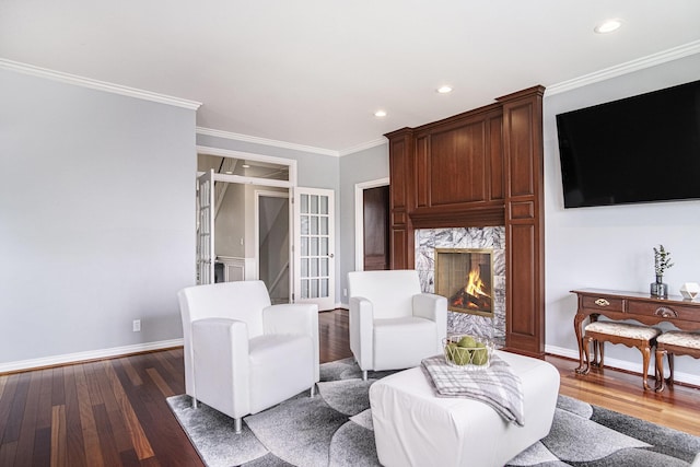 7340 Royal Ridge Dr SE, Caledonia, MI 49316 - living room featuring a high end fireplace, crown molding, dark wood finished floors, baseboards, and recessed lighting