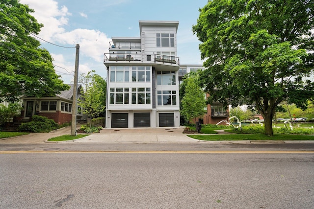 211 W Kingsley St, Ann Arbor, MI 48103 - view of front of house with an attached garage, driveway, and a balcony
