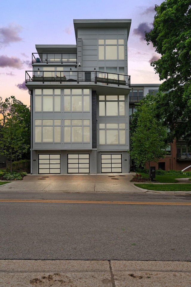 211 W Kingsley St, Ann Arbor, MI 48103 - property at dusk featuring an attached garage and concrete driveway