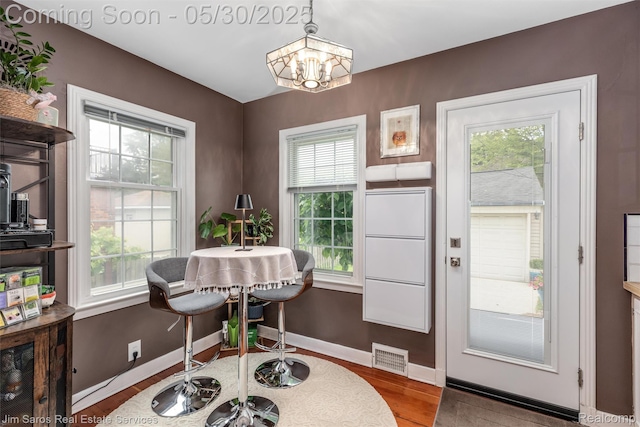 441 Mckinley Ave, Grosse Pointe Farms, MI 48236 - dining room with plenty of natural light, a chandelier, wood finished floors, and baseboards