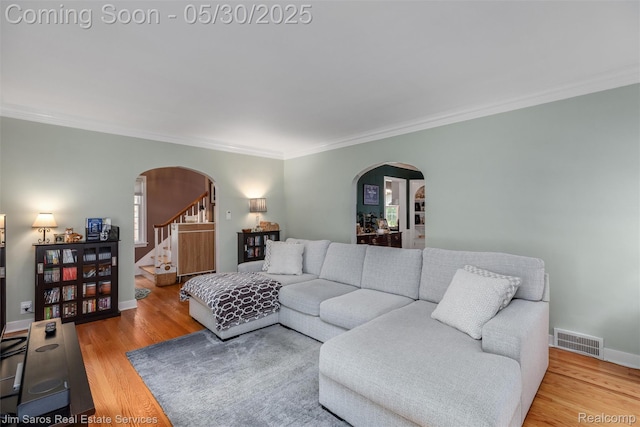 441 Mckinley Ave, Grosse Pointe Farms, MI 48236 - living area with arched walkways, ornamental molding, stairs, and wood finished floors