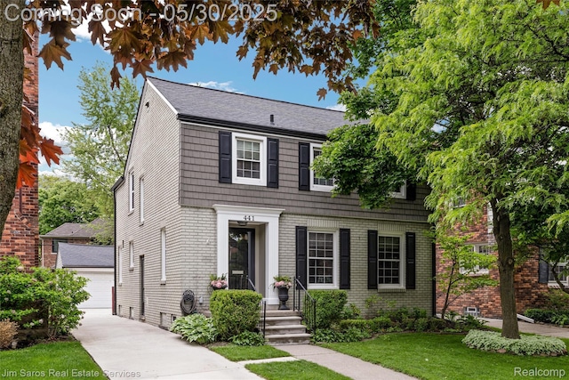 441 Mckinley Ave, Grosse Pointe Farms, MI 48236 - view of front facade featuring a front lawn, brick siding, an outdoor structure, and a garage