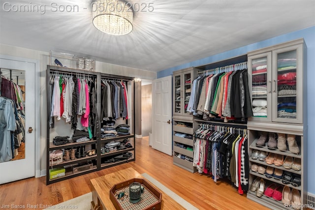 441 Mckinley Ave, Grosse Pointe Farms, MI 48236 - spacious closet with a chandelier and light wood finished floors