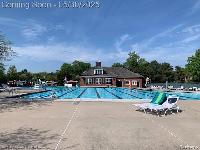 441 Mckinley Ave, Grosse Pointe Farms, MI 48236 - community pool with a patio and view of scattered trees