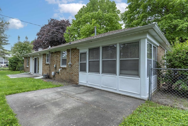 1202 Avalon Ave, Saginaw, MI 48638 - view of front of property featuring brick siding and a patio