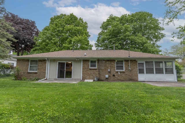 1202 Avalon Ave, Saginaw, MI 48638 - back of property featuring brick siding and a sunroom