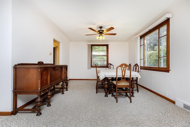 1202 Avalon Ave, Saginaw, MI 48638 - dining area with baseboards, carpet floors, and a ceiling fan