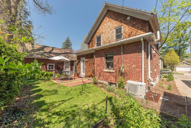 511 W Jefferson St, Ann Arbor, MI 48103 - back of house with ac unit, a lawn, and a patio area