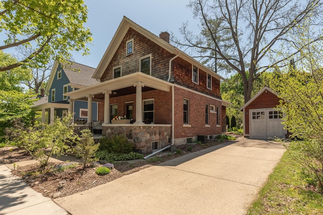 511 W Jefferson St, Ann Arbor, MI 48103 - view of front of home with a porch, a chimney, an outdoor structure, a garage, and brick siding