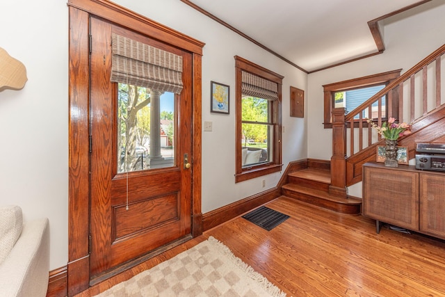 511 W Jefferson St, Ann Arbor, MI 48103 - entryway featuring stairway, light wood finished floors, baseboards, and crown molding