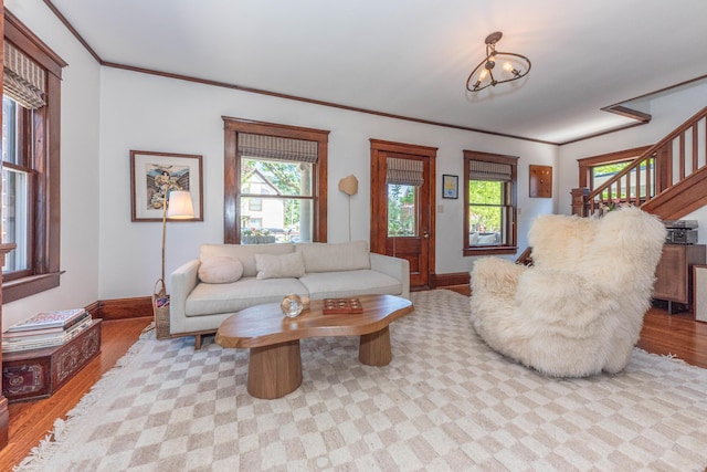 511 W Jefferson St, Ann Arbor, MI 48103 - living area featuring baseboards, light wood-style floors, stairway, and ornamental molding