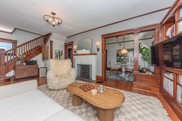 511 W Jefferson St, Ann Arbor, MI 48103 - living area featuring wood finished floors, stairway, a fireplace, and crown molding
