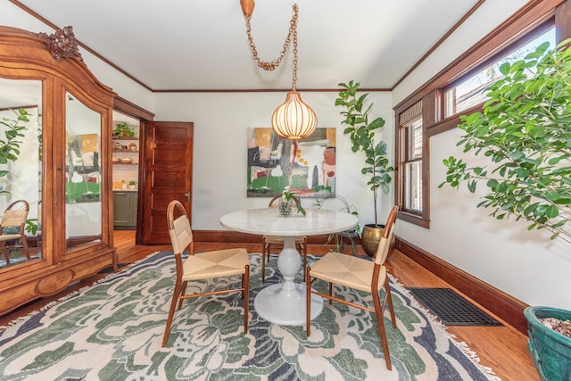 511 W Jefferson St, Ann Arbor, MI 48103 - dining area featuring wood finished floors, baseboards, and ornamental molding