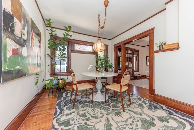 511 W Jefferson St, Ann Arbor, MI 48103 - dining room with baseboards, wood finished floors, and ornamental molding