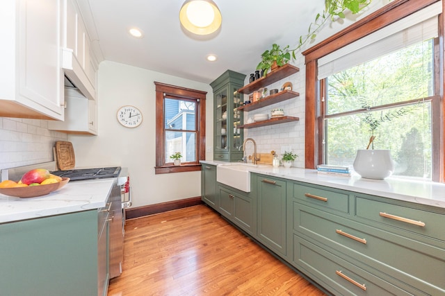 511 W Jefferson St, Ann Arbor, MI 48103 - kitchen with a sink, green cabinetry, appliances with stainless steel finishes, light wood-style floors, and baseboards