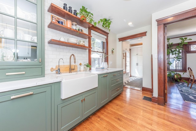 511 W Jefferson St, Ann Arbor, MI 48103 - kitchen with green cabinets, a sink, healthy amount of natural light, and light wood-type flooring