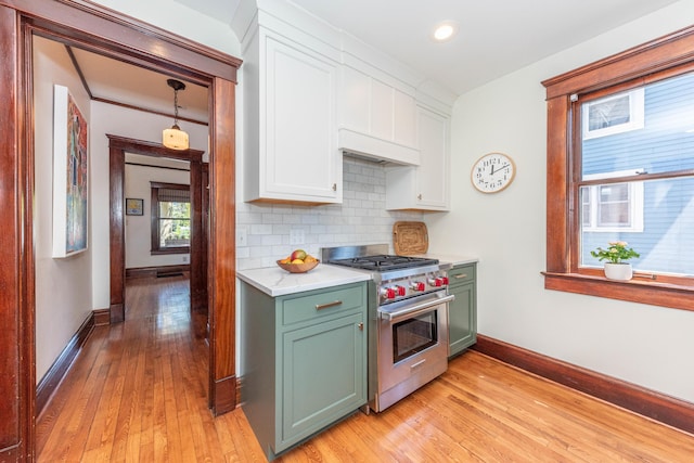 511 W Jefferson St, Ann Arbor, MI 48103 - kitchen with luxury stove, green cabinets, white cabinetry, light countertops, and light wood finished floors