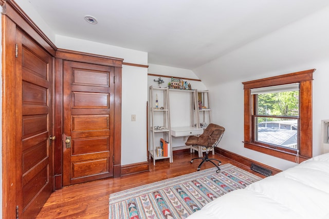 511 W Jefferson St, Ann Arbor, MI 48103 - bedroom with vaulted ceiling, wood finished floors, baseboards, and an office area