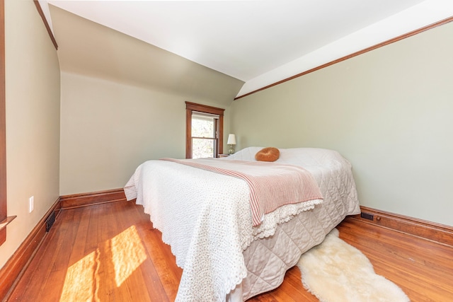 511 W Jefferson St, Ann Arbor, MI 48103 - bedroom with lofted ceiling, wood finished floors, and baseboards