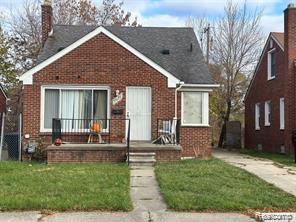 9910 Coyle St, Detroit, MI 48227 - bungalow featuring brick siding, a chimney, and a front yard