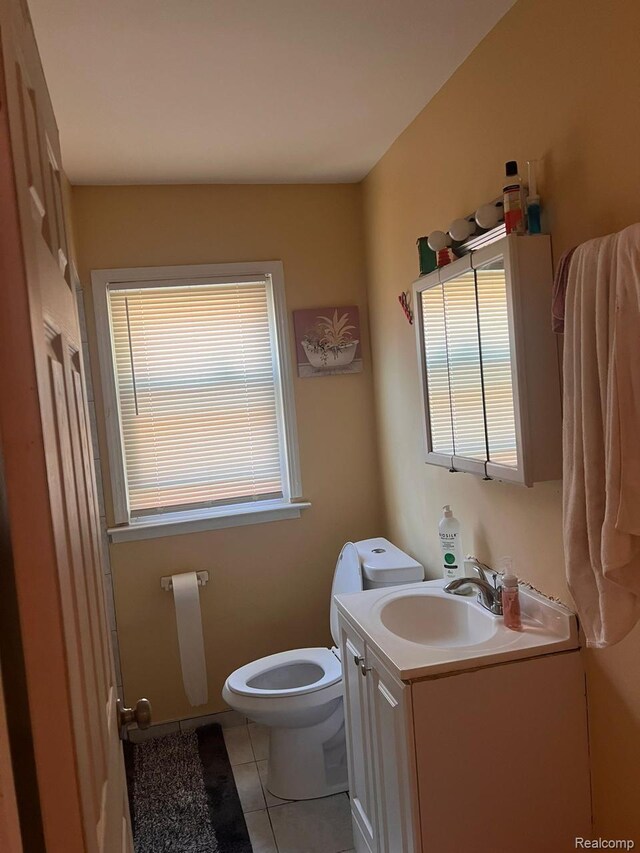 9910 Coyle St, Detroit, MI 48227 - bathroom featuring vanity, toilet, healthy amount of natural light, and tile patterned floors